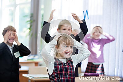 Happy kids in school class. Children have doing exercises. Primary School Editorial Stock Photo