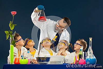 Happy kids with scientist doing science experiments in the laboratory Stock Photo