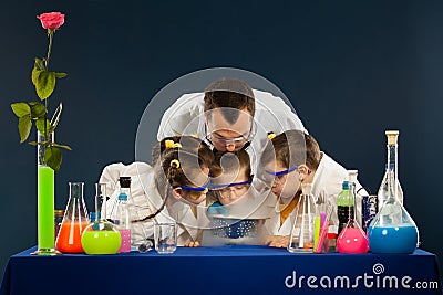 Happy kids with scientist doing science experiments in the laboratory Stock Photo