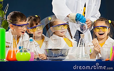 Happy kids with scientist doing science experiments in the laboratory Stock Photo