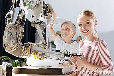 Happy kids taking part in the construction of robot Stock Photo