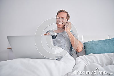 Relaxed mature man enjoying coffee in bed Stock Photo