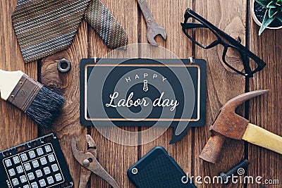 Happy Labor day background concept. Flat lay of construction blue collar handy tools and white collar`s accessories over wooden Stock Photo