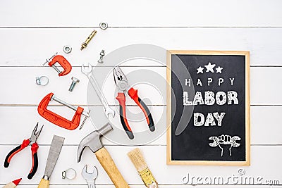 Happy Labor Day background concept. Flat lay of construction handy tools with black chalkboard with happy labor day text over Stock Photo