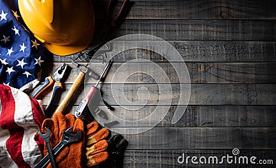 Happy Labor day concept. American flag with different construction tools on dark wooden background, with copy space for text Stock Photo