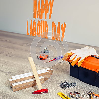 Happy Labour Day text in the image. Construction and production tools with a background celebrating Happy Labor Day. Stock Photo