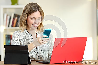 Happy lady using multiple colorful devices Stock Photo