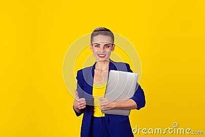 Happy with laptop. Closeup portrait college student looking smiling holding pad tablet computer showing thumbs up gesture with Stock Photo