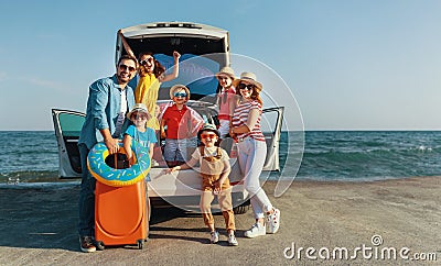 Happy large family in summer auto journey travel by car on beach Stock Photo