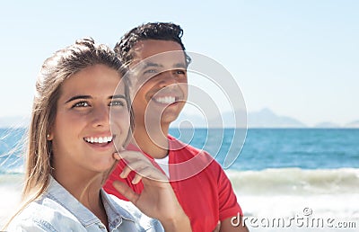 Happy latin couple at beach Stock Photo