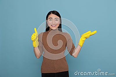 Happy laughing asian pointing housewife fingers aside at copy space thumb up Stock Photo