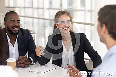 Happy laughing black man and woman break in business negotiations Stock Photo