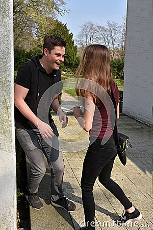 Happy laughing teenage boy meets his girlfriend Stock Photo