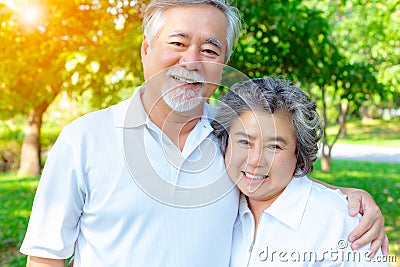 Happy life and long lived concept. Handsome old man and beautiful old woman embracing together, look at camera. Older couple have Stock Photo