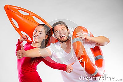 Happy lifeguard couple with equipment Stock Photo