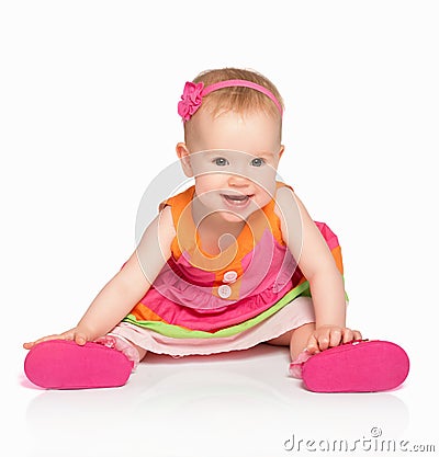 happy little baby girl in bright multicolored festive dress isolated Stock Photo