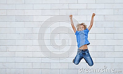 Happy little boy jumps on high. People, childhood, happiness, freedom, movement concept Stock Photo