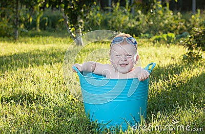 Happy little boy looking out from swimming pool Stock Photo