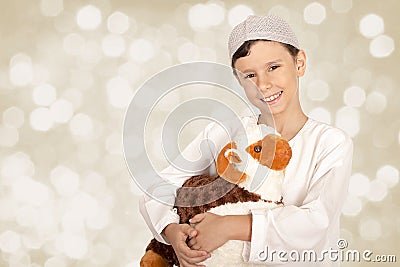 Happy little boy playing with his sheep toy - celebrating Eid ul Stock Photo