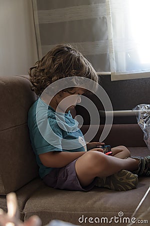 Happy little Boy Playing Video Games. Child using video game Controller. Kid with Joystick playing Computer Game. Stock Photo