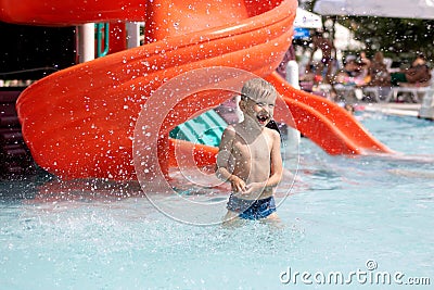 Happy little boy plays in swiming pool Stock Photo