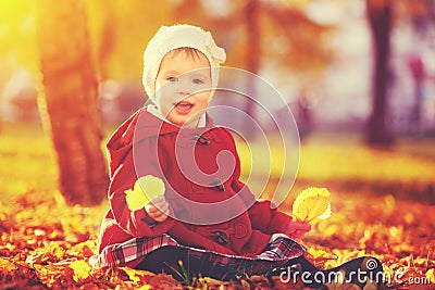 Happy little child, baby girl laughing and playing in autumn Stock Photo