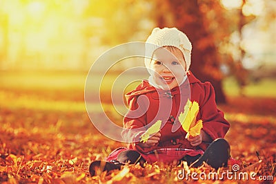 Happy little child, baby girl laughing and playing in autumn Stock Photo