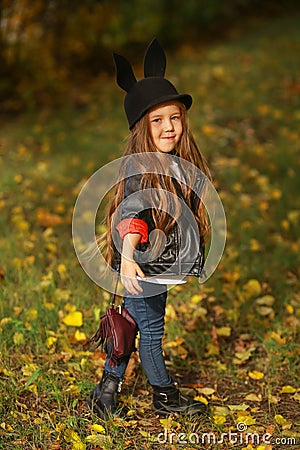 Happy little child, baby girl laughing and playing in the autumn on the nature walk outdoors. Stock Photo