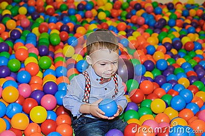 Happy little child playing at colorful plastic balls playground Stock Photo