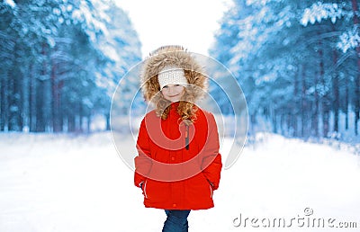 Happy little child in red jacket outdoors in winter Stock Photo