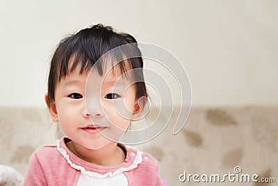 happy little child smiling after wake up and playing over the bed in a relaxed morning Stock Photo