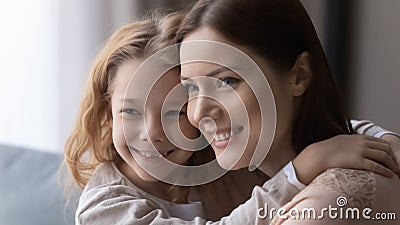 Happy little daughter cuddle to mom share most desired dreams Stock Photo