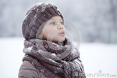 Happy little girl on the background of a winter park Stock Photo