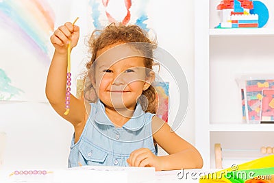Happy little girl with beads on a string Stock Photo