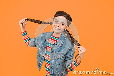 Happy little girl with braids wear denim clothes, modern style concept Stock Photo