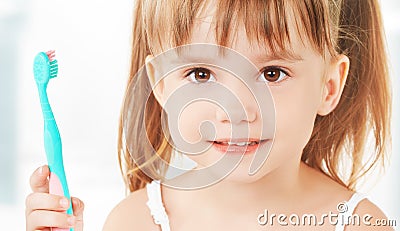 Happy little girl brushing her teeth Stock Photo