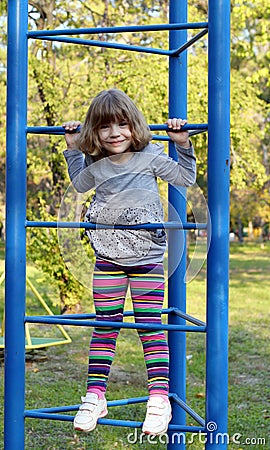 Little girl climb on park playground Stock Photo