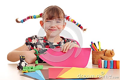 Happy little girl cutting paper Stock Photo