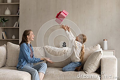 Happy little girl feeling excited of getting present gift. Stock Photo