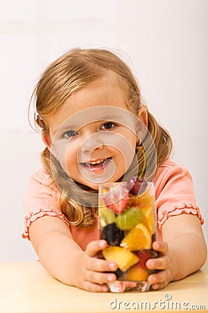 Happy little girl with fruity refreshment Stock Photo