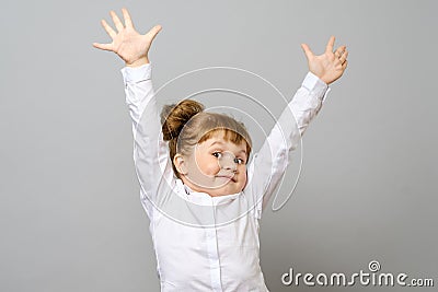 Happy little girl with her hands up Stock Photo