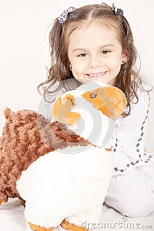 Happy little girl with her sheep toy - celebrating Eid ul Adha - Stock Photo