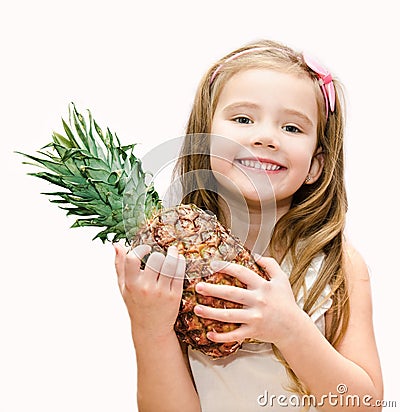Happy little girl holding ripe whole pineapple Stock Photo