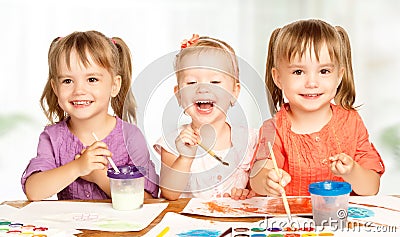 Happy little girl in kindergarten draw paints Stock Photo