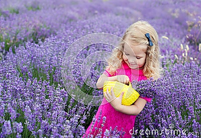 Happy little girl is in a lavender field Stock Photo