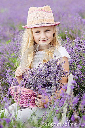 Happy little girl is in a lavender field Stock Photo