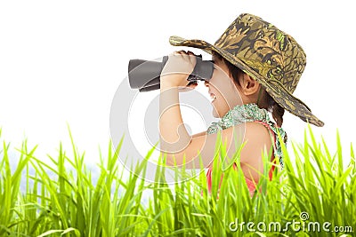 Happy little girl looking through binoculars outdoors. Stock Photo