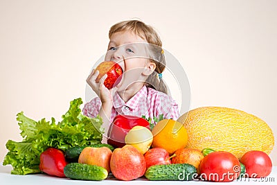 Happy little girl and a lot of fruit and vegetables. Stock Photo