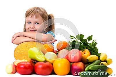 Happy little girl and a lot of fruit and vegetables. Stock Photo
