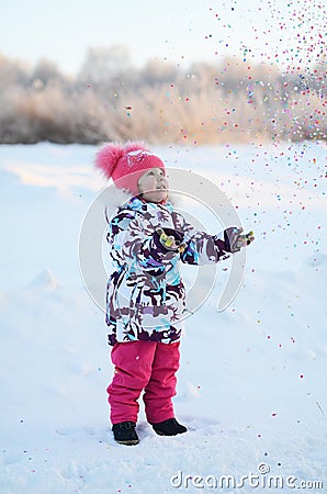 Happy little gir throws confetti Stock Photo